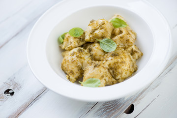 Close-up of italian ravioli served with basil pesto, studio shot