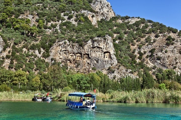 Tourist boats by the historic rock tombs in Dalyan, TURKEY.