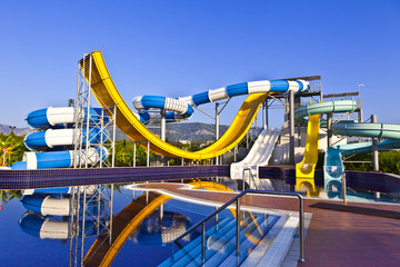 Blue, white and yeloow waterslide in a pool.