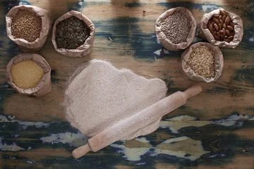 Selbstklebende Fototapeten Grains, flour and rolling pin on wooden table © frameworks2014
