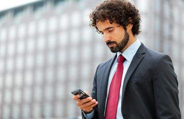 Mature businessman using his phone
