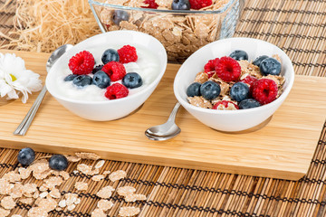 Bowls with berries, muesli and yoghurt