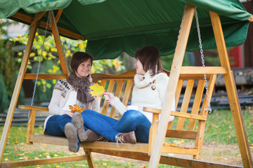 Mother with daughter on a swing