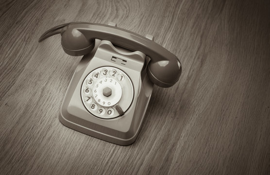 Vintage telephone on hardwood surface