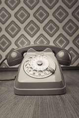 Vintage telephone on diamond wallpaper