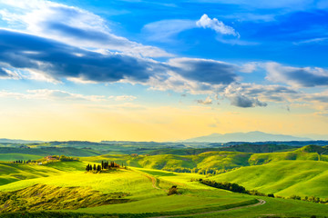 Fototapeta na wymiar Tuscany, rural sunset landscape. Countryside farm, white road an