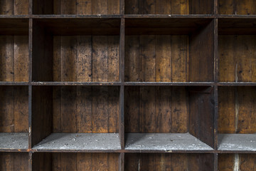 Old, distressed, empty wooden storage shelves