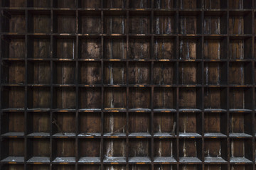 Fototapeta premium Old, distressed, dark wood storage shelves with random tools