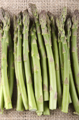 Fototapeta premium green asparagus on jute cloth