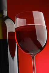 bottle with red wine and glass