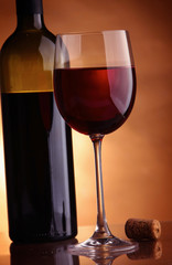 A full wineglass and a botte, closeup