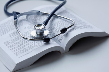 a medical stethoscope on an open book