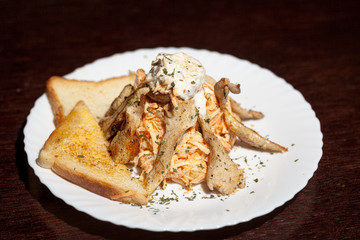 chicken salad with vegetables on wooden background