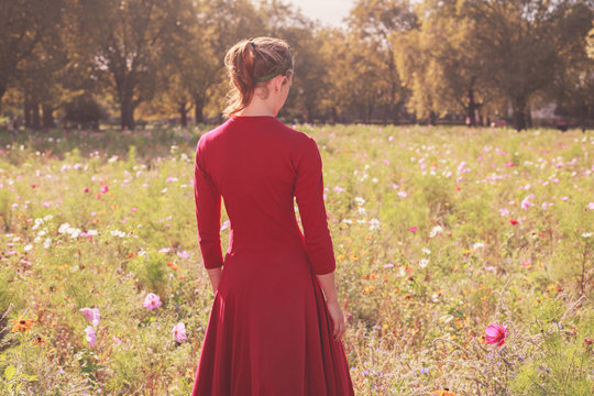 Young woman in meadow at sunset
