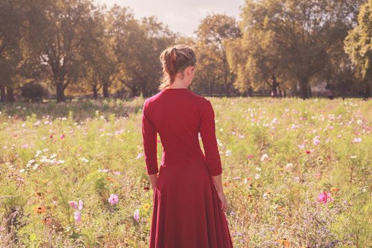 Young woman in meadow at sunset
