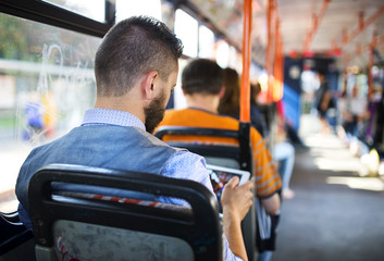 Hipster businessman with mobile phone on tram