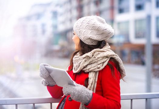 Pregnant Woman In Winter With Digital Tablet