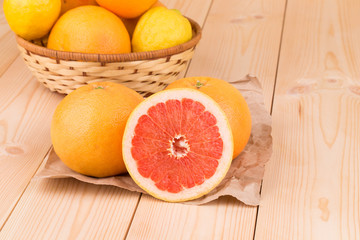 Fresh sliced grapefruits on wood table.