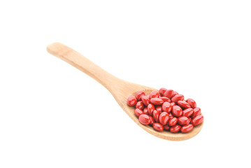 Pills drug on wooden spoon isolated on white background