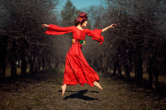 Girl in red dress soars.
