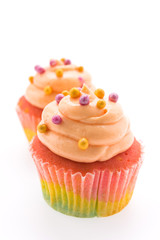 Colorful cupcakes isolated on white
