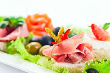 Cold snack with  ham,  salmon and olives