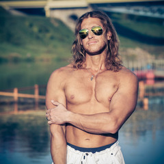 seminude sexy caucasian fit man in sunglasses 