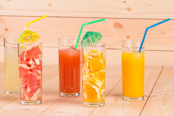 Transparent glasses with citrus fruits and juice