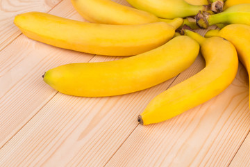 Fototapeta na wymiar Bunch of bananas fruit on a wooden background