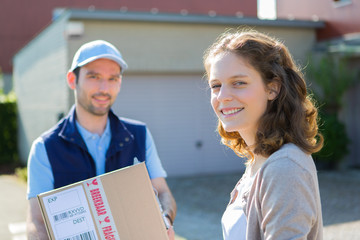 Young attractive delivery man on his way to customer