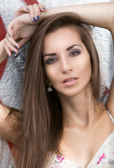 Fototapeta premium portrait of sexy slim brunette woman leaning against wall