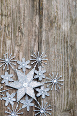 Snowflake on grunge wooden background.