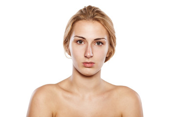 beautiful blonde without makeup posing on white background
