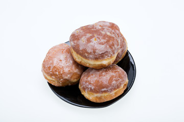 whole donuts on the black porcelain plate