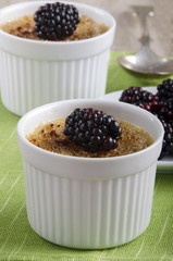 Fototapeta na wymiar creme brulee with blackberries in a small bowl