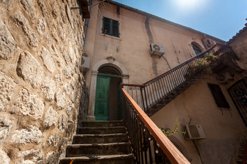 Fototapeta na wymiar staircase at backyard of old building at sunny day