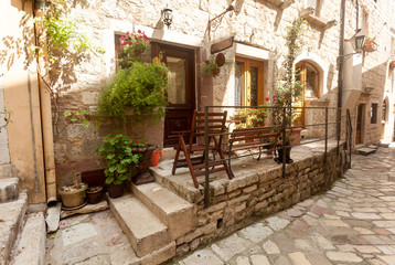 street of old town decorated with pots and flowers