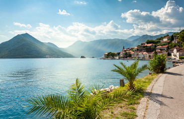 view from embankment on sea bay surrounded by mountains at sunny