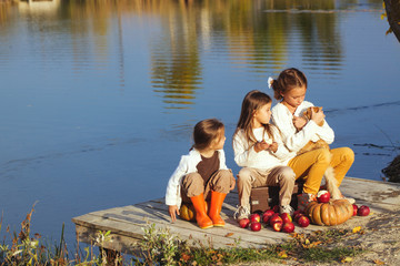 Kids playing near the lake in autumn