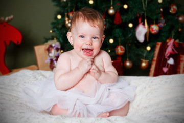 Obraz na płótnie Canvas Portrait of a happy baby girl at Christmas