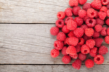 Fresh ripe raspberries on wooden table