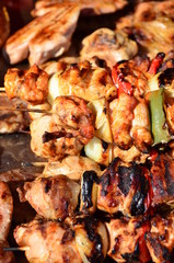 Skewered on wooden sticks tasty pork meat and vegetables mix