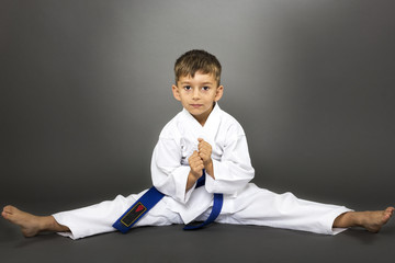 Adorable boy in kimono training on the floor