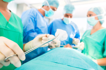 Surgeons operating patient in operating room