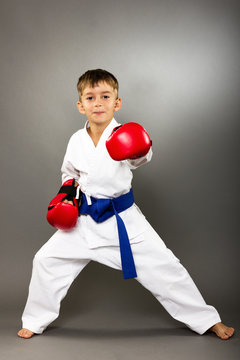 Little boy with red gloves training karate