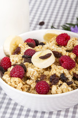 granola with fruits and bottle of fresh milk
