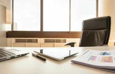 table work in office room of manager with tablet and report