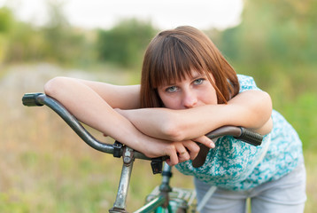 Beautiful girl with an old bicycle.