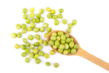 Green peas in a wooden spoon on a white background. © dibas99