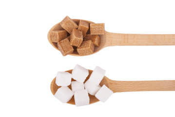 Refined sugar in the spoons on a white background.